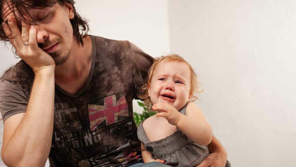 crying toddler with dad