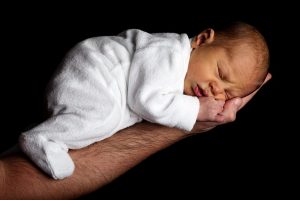 Dad holding Baby on arm, Baby asleep