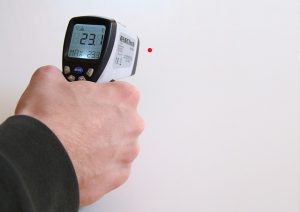 Man holding digital thermometer