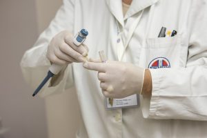 Doctor, rubber gloves, medicine dispenser