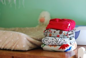 Pile of Baby clothes, changing mat