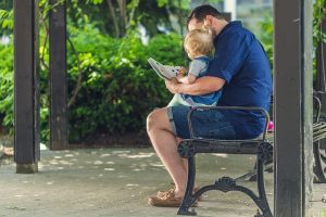 Father reading book to Baby