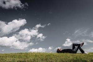 Man relaxing, grass field