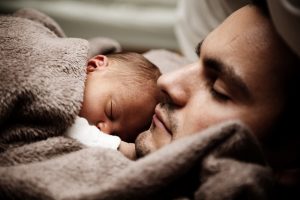 Baby sleeping on Dad, building a bond