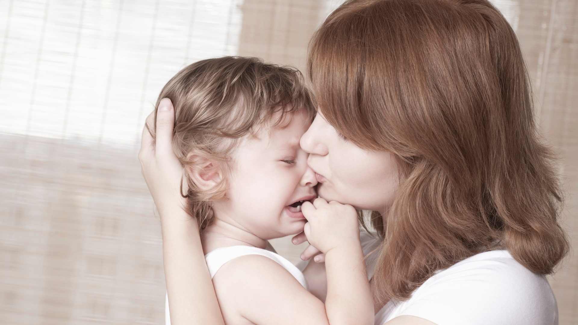 mom holding a crying child