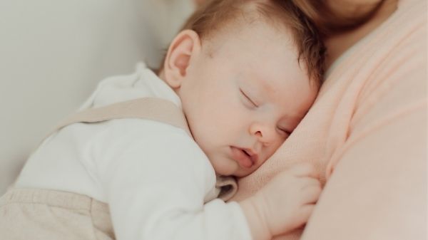 holding sleeping baby