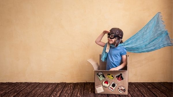 happy child in box playing as a pilot