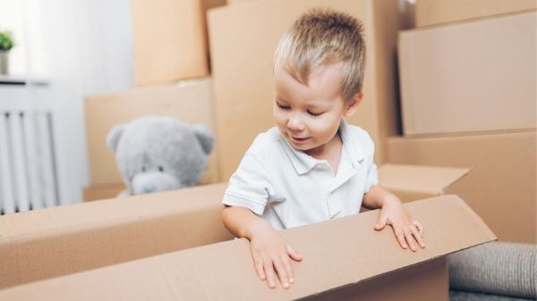 toddler playing in empty box