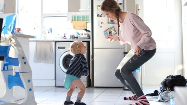 toddler dancing in kitchen with mom