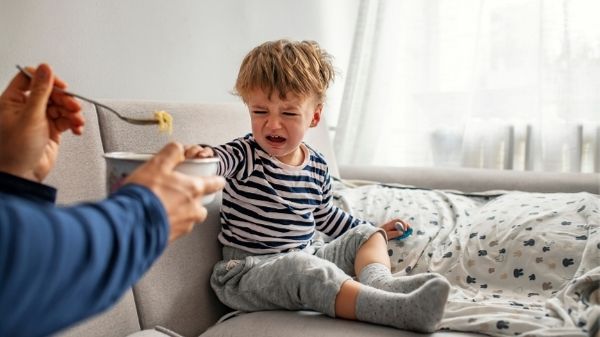 toddler having a tantrum on the sofa