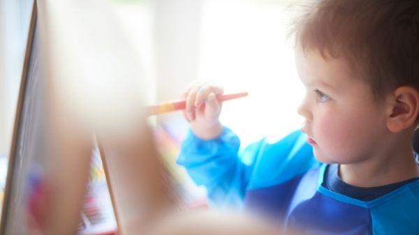 toddler painting a picture