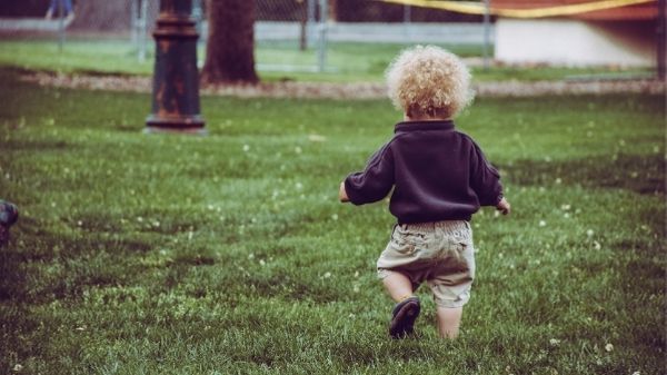 toddler running on grass