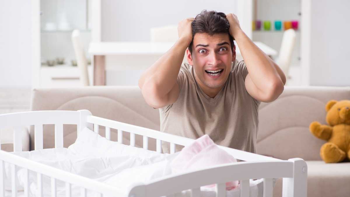 dad next to crib frustrated