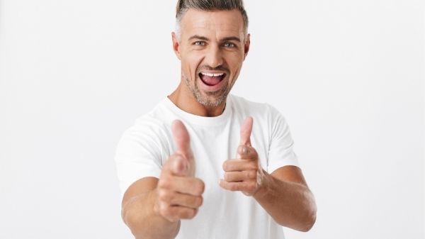 happy man pointing at camera