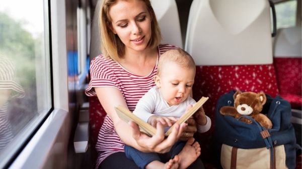 mom reading to baby whilst travelling