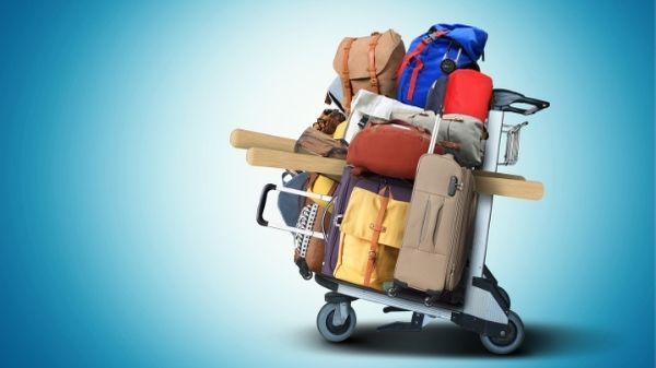 overpacked suitcases on trolley