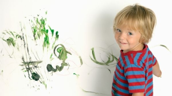 toddler painting the wall