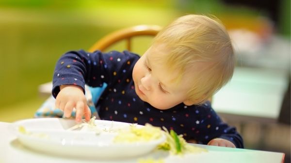 toddler playing with food