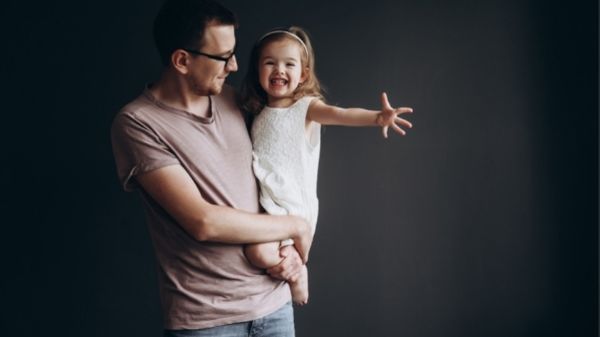 dad holding his daughter