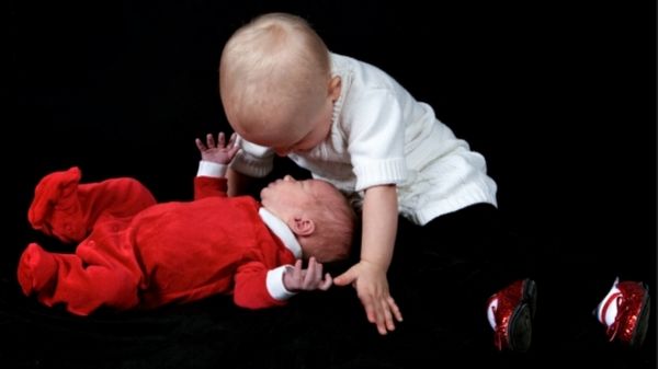 toddler looking after his baby sibling