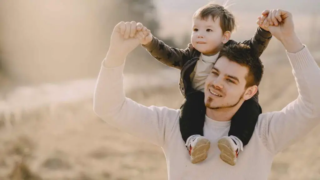 dad with son on shoulders