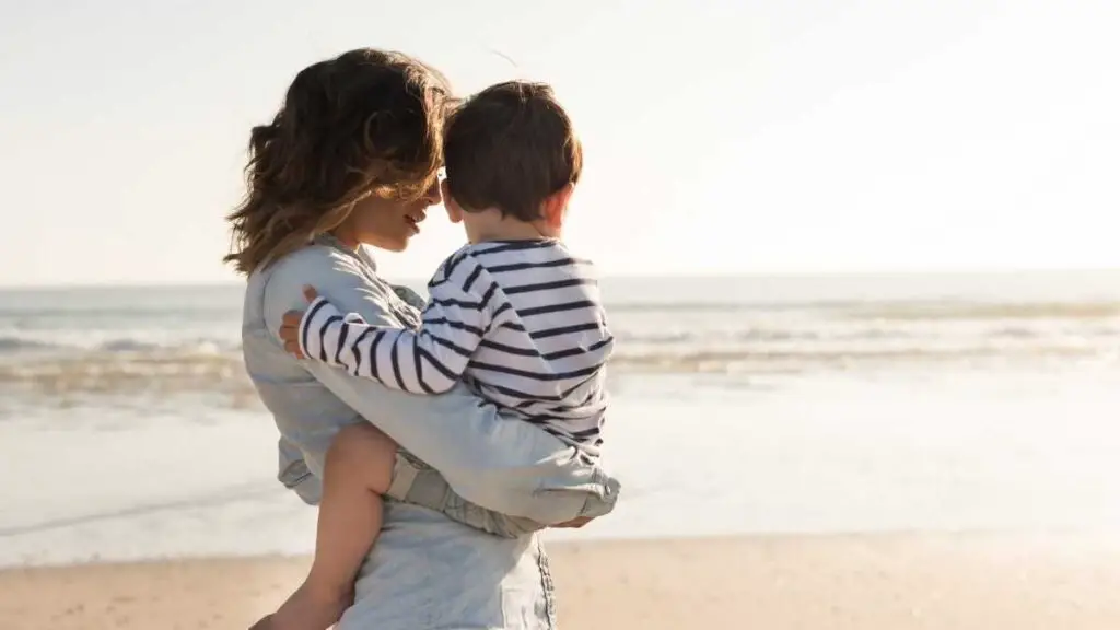 mom and toddler on a beach relaxing