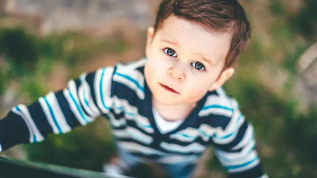 toddler boy looking up at the camera