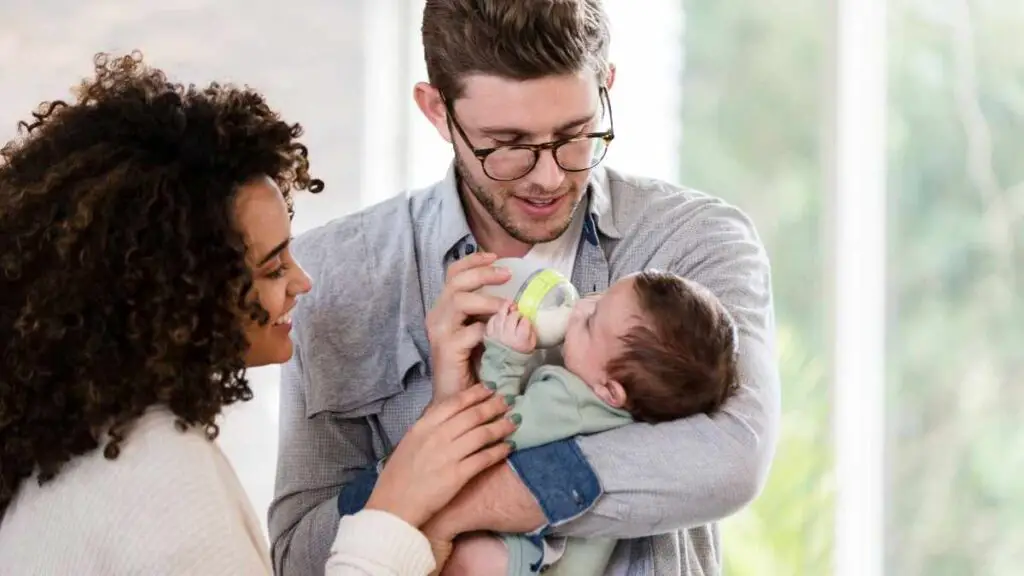 young dad feeding baby