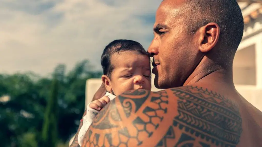 dad keeping newborn baby safe