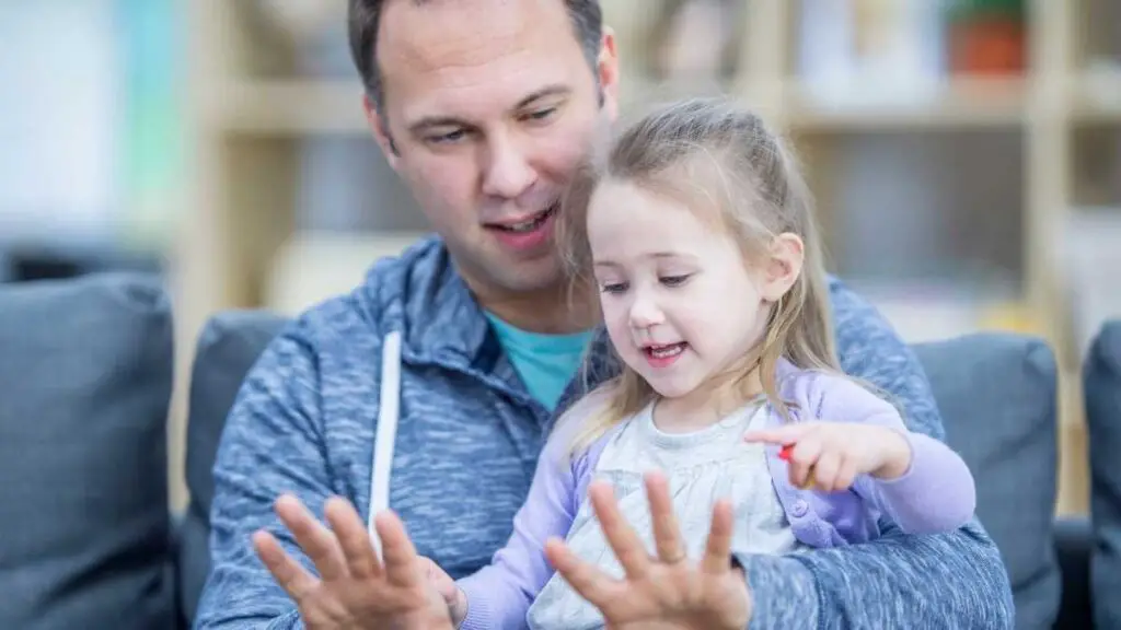 dad playing with toddler daughter