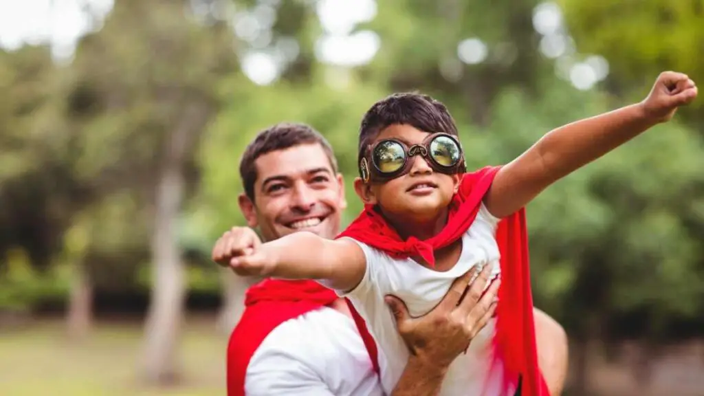 father playing superheroes with his son