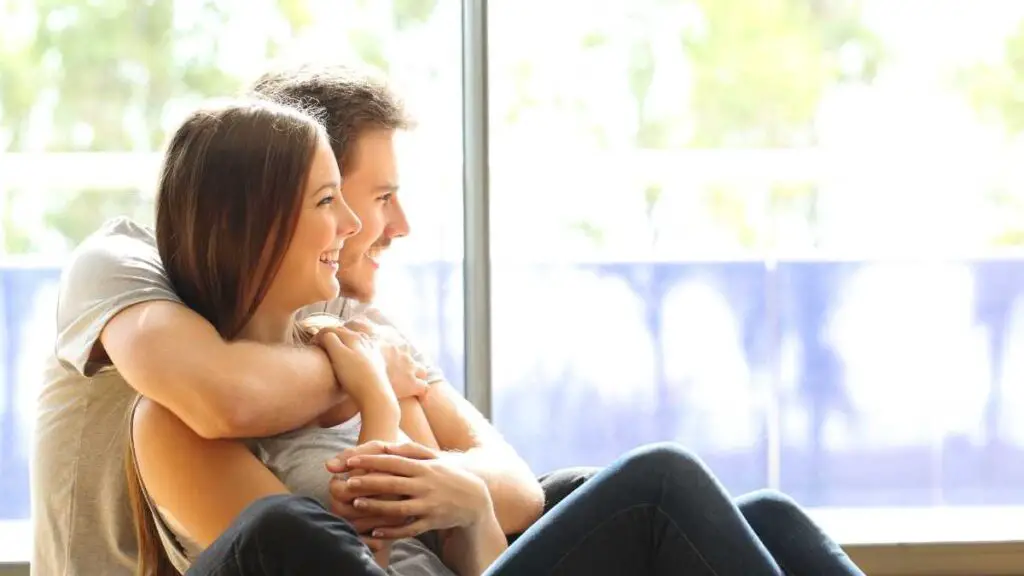 man and woman hugging and smiling