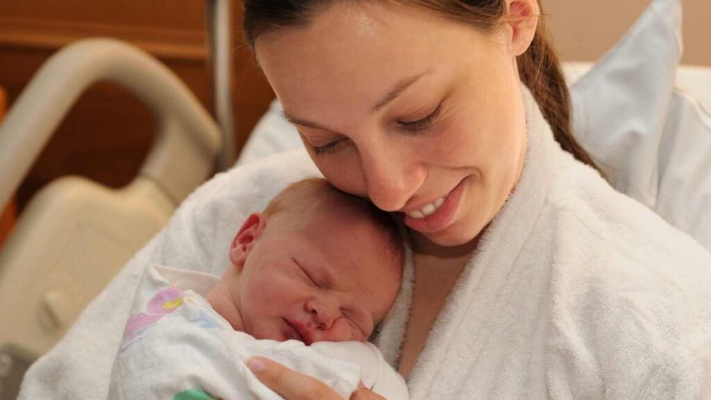 new mom holding newborn in hospital