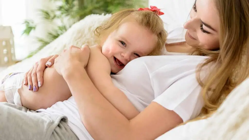 toddler happy laying on mom