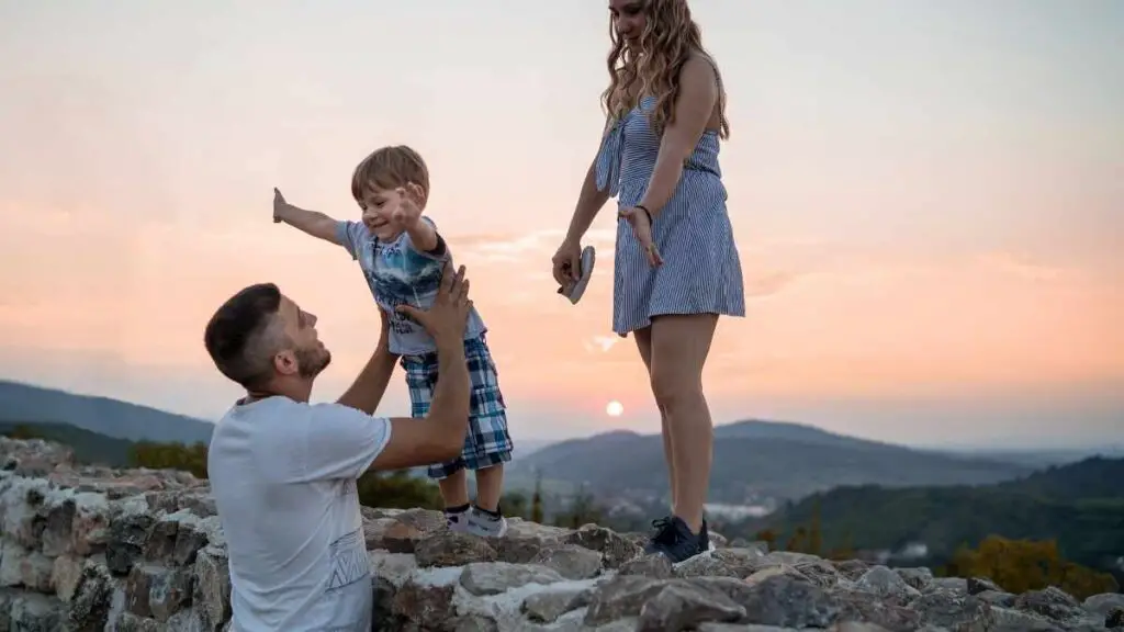 dad playing with toddler on wall