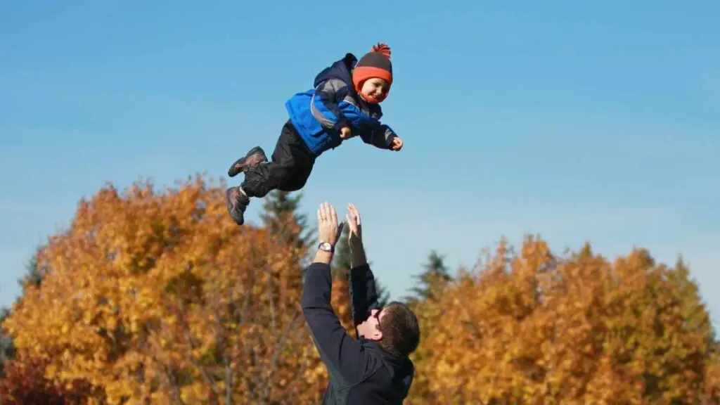 dad playing with toddler outside