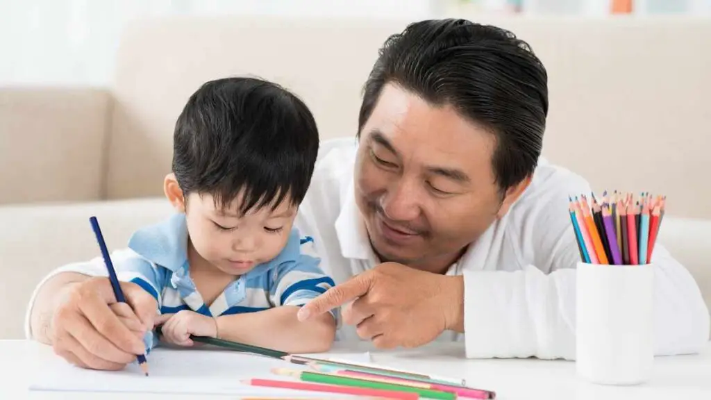 dad teaching toddler