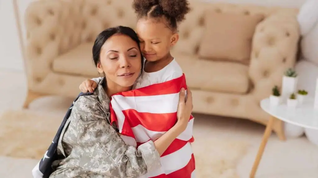 little girl attached to mom wearing us flag