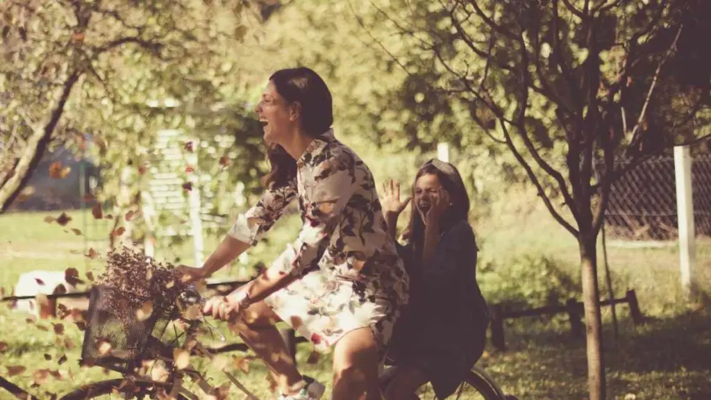 mom and daughter having fun on bike