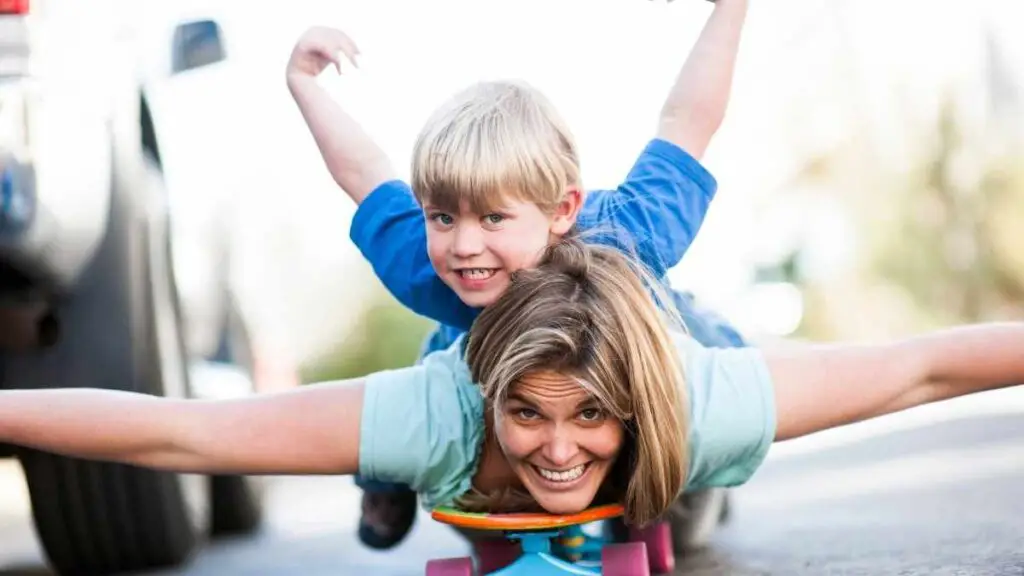 mom playing with her boy on skateboard