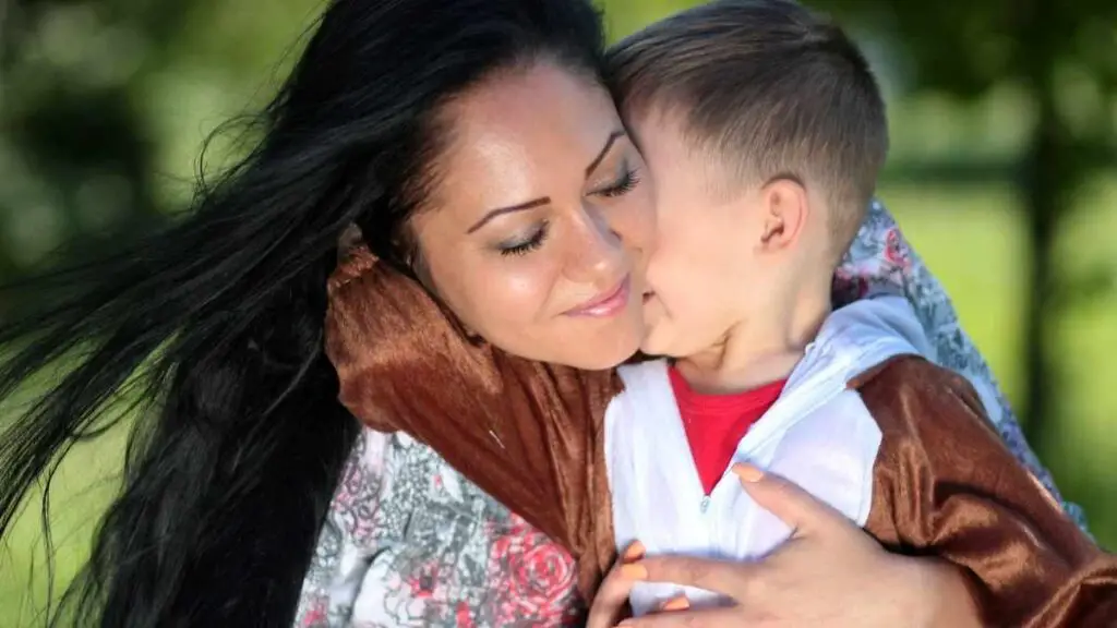 mom showing son she loves him hugging