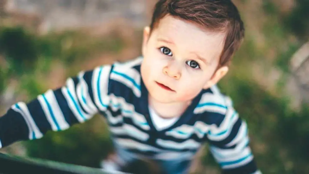 toddler boy looking up at camera