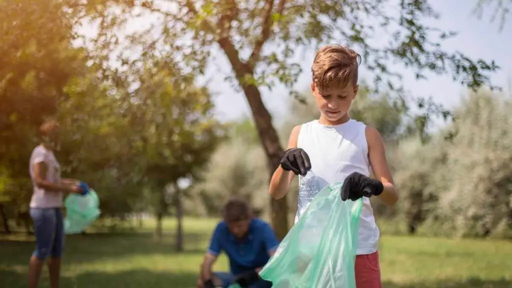 child picking up litter