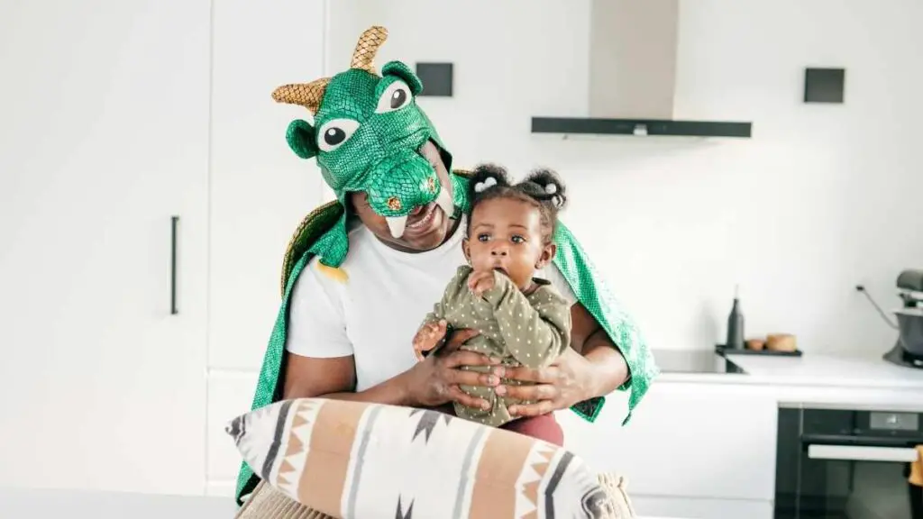 dad dressed as dragon and toddler interacting