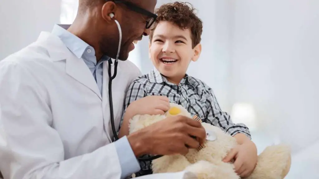 doctor helping toddler