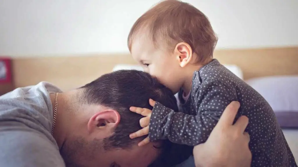 happy baby kissing dad