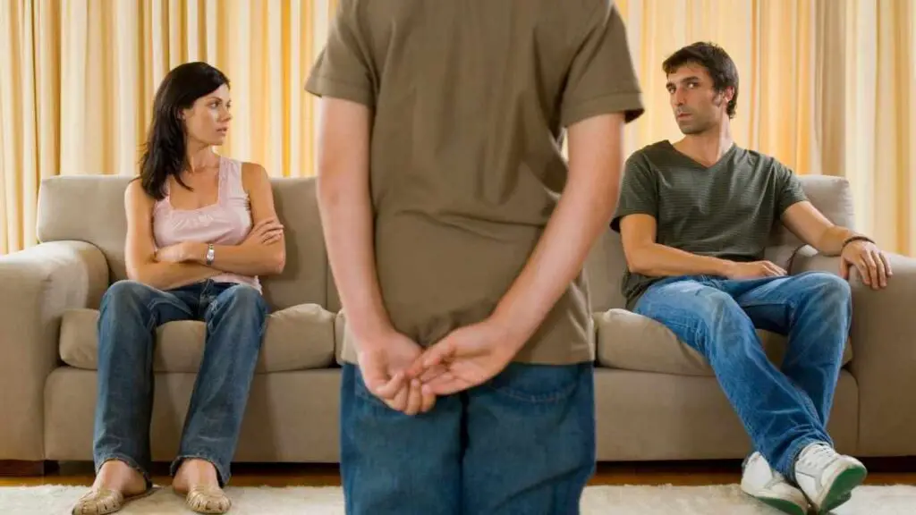 parents on sofa correcting childs behavior