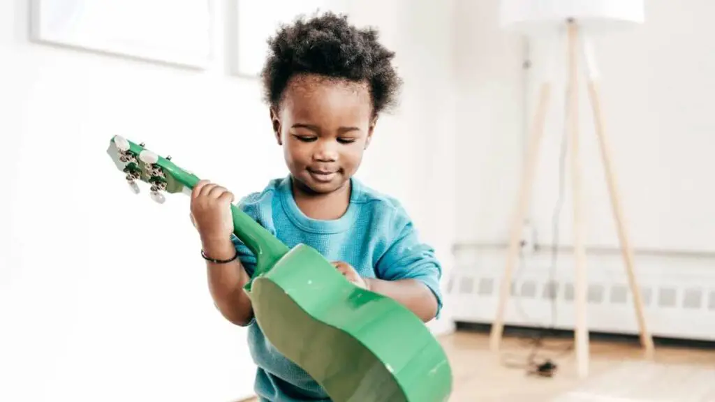 toddler playing guitar