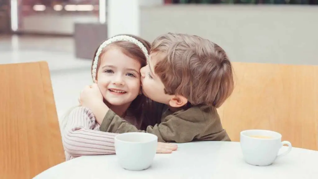 toddler showing affection by kissing