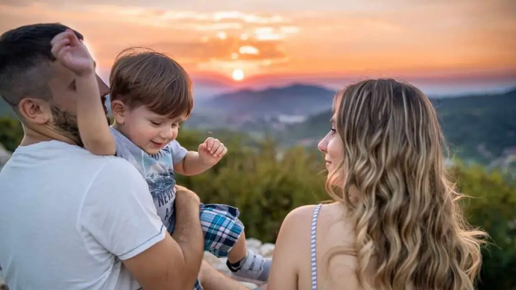 toddler with mum and dad outside